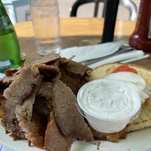 a plate of meat and pita chips