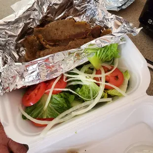 Gyro sandwich deconstructed.  It usually comes on a pita with tahini sauce.