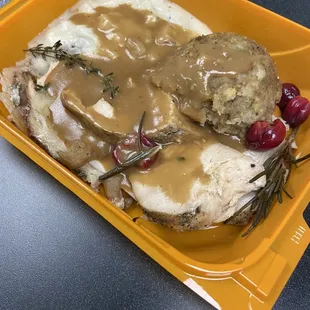 Fruit stuffed turkey with stuffing and potatoes.