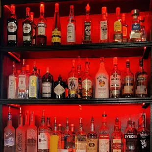 a shelf full of liquor bottles