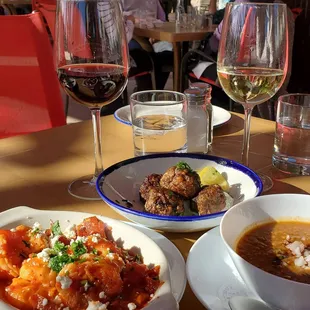 a table of food and wine glasses