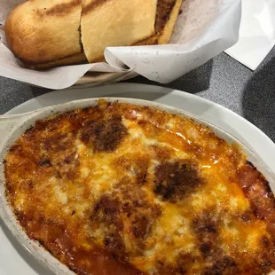 Baked lasagna with bread.  The cheese is still bubbling hot!!