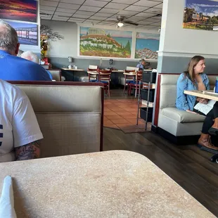 people sitting at tables in a restaurant