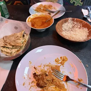 Garlic naan, butter chicken, basmati rice, and my son who couldn&apos;t eat things fast enough.