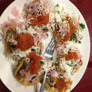 Garnachas! Fried mini tortillas with ground beef, cabbage, cilantro, salsa, and queso fresco. Yum!