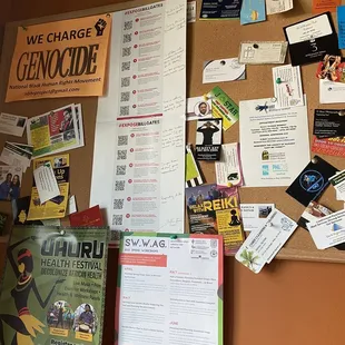 a cork board with various items on it