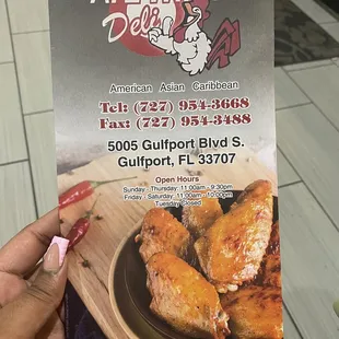 a person holding up a menu