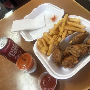 a tray of fried chicken and french fries