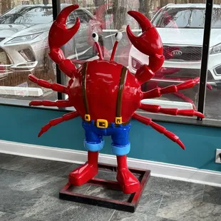 a red crab with blue pants