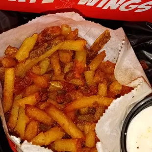 a box of fries and a bowl of dip