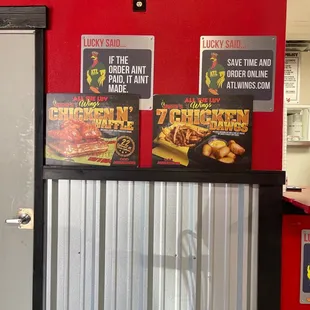 a red wall with posters on it