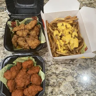 Boneless wings Spicy ATL (top) Cajun hot (bottom) and cheese fries it was all really good
