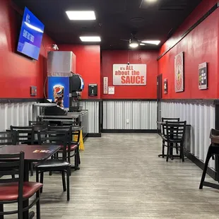 a restaurant with red walls and tables and chairs