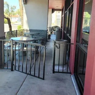 a view of a patio with a table and chairs