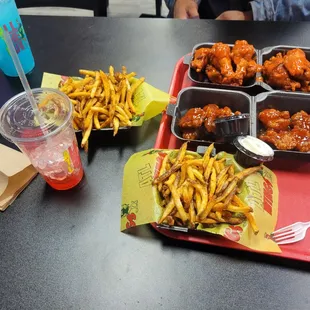 Honey habanero boneless wings with Cajun fries and mild traditional wings with Cajun fries, blue Raspberry kool-aid and tropical Kool-aid