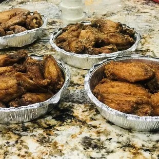 a variety of wings in tinfoils