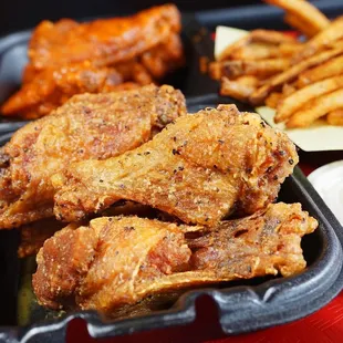 a tray of fried chicken and french fries