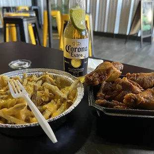ATL style Wings and cheese fries  Washed down Corona style!