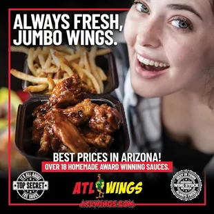 a woman holding a tray of wings