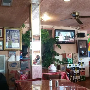 Filled wall to wall from the floor up with family pictures, loyal patrons, a map of El Salvador!
