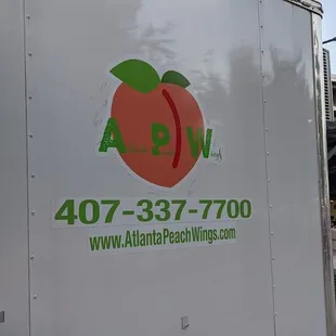 a truck with a peach on the side