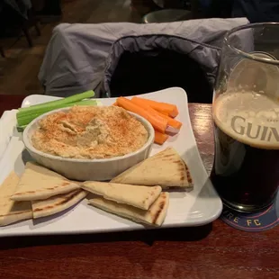 a plate of food and a glass of beer