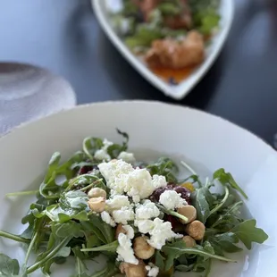 a plate of salad and a glass of wine