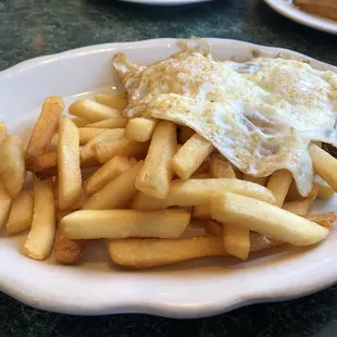Eggs over medium, corned beef has and fries