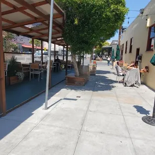 Outdoor table seating on the street &amp; patio. Limited indoor seats bc COVID. Big food menu. Watered-down cold brew. Thu/Fri wine after 5pm