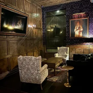 a living room with couches, chairs, and a flat screen tv