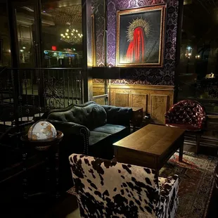 a living room with a cow print chair