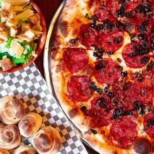 a pepperoni pizza and a salad