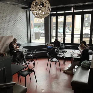 people sitting at tables in a coffee shop