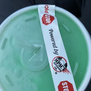 a green plastic container with a stop sign on it