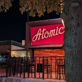 a woman sitting on a bench in front of a restaurant