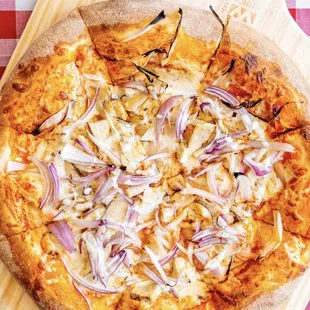 a pizza with onions and cheese