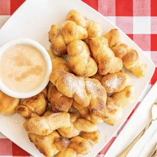 a plate of croissants and dipping sauce