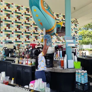 a man pouring a drink at a bar