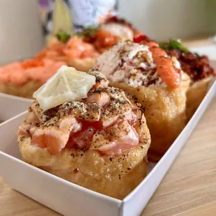 Front: Lemon pepper salmon, myungran crab, grilled spicy pork Back: creamy myungran, fresh salmon, spicy tuna