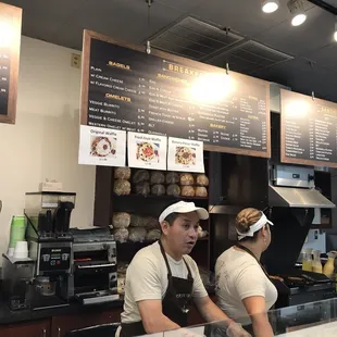 two people working behind the counter