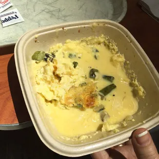 a person holding a bowl of food