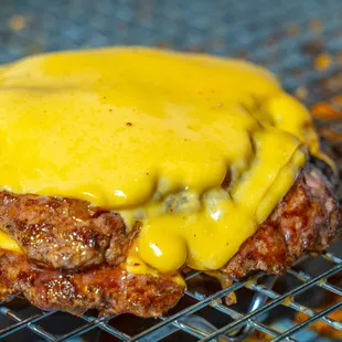 a hamburger covered in cheese