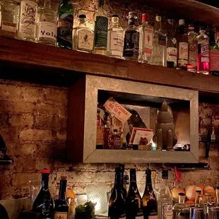 a bar with bottles of alcohol on the shelves