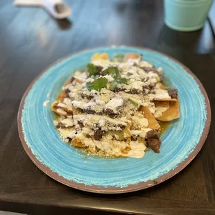 a plate of nachos on a table