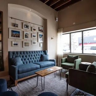 a living room with blue couches