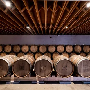 barrels stacked on pallets in a cellar