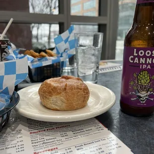 a beer and a sandwich on a table