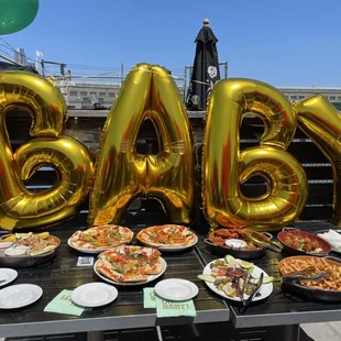 baby balloons and food on a table