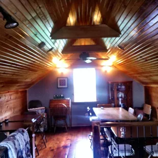 a loft with a dining table and chairs