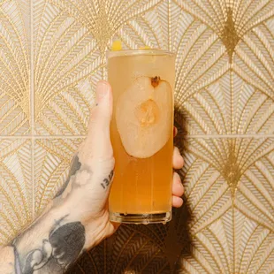 a person holding a glass of beer